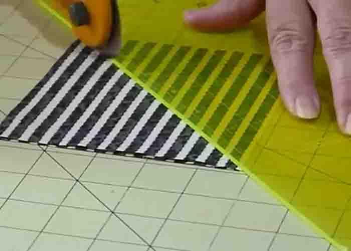 Cutting the 5" squares diagonally for the quilt block