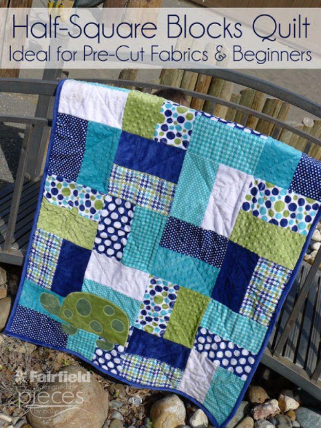 Half square blocks quilt graphic, navy, turquoise and lime minky squares with a green turtle applique, on a railing