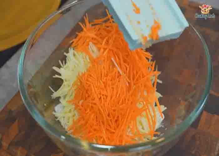 Grating the potato and carrot for the potato balls recipe