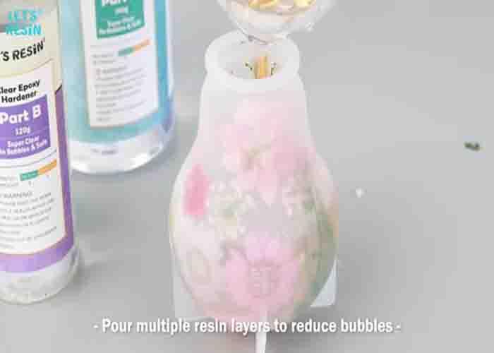 Pouring the epoxy into the light bulb silicone mold