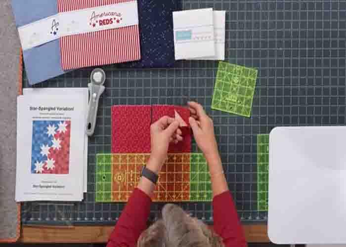 Cutting the layer cakes into fourths for the star spangled variation quilt