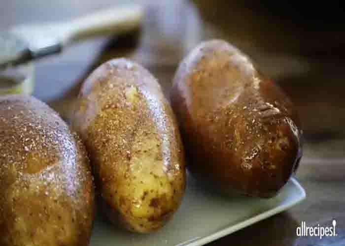Seasoning the potatoes before baking