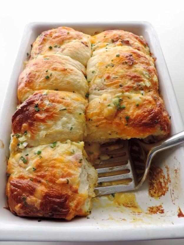 Breakfast casserole of canned biscuit pieces, ham, eggs and cheese baked into sliceable squares recipe worth making twice