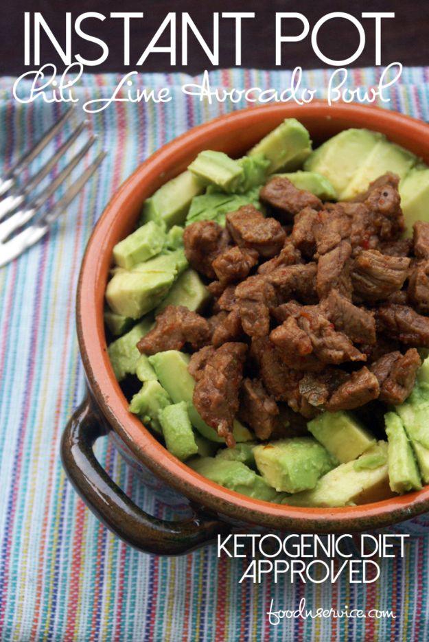 Instant Pot chili lime steak cubes ringed by diced green avocado in a terracotta bowl on a striped cloth