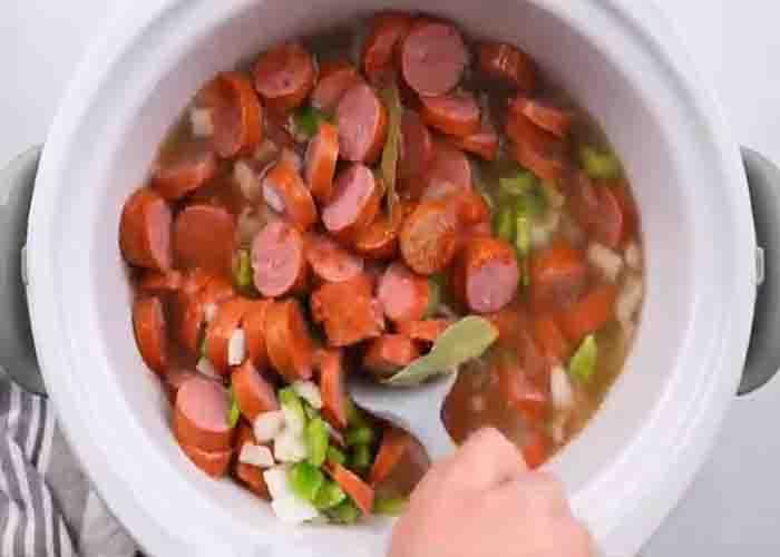 Mixing the red beans and sausage in the slow cooker