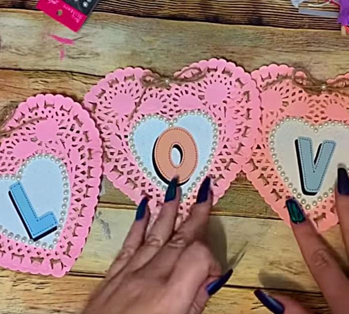 Learn to make a DIY Paper Doily Heart Banner with materials from Dollar Tree