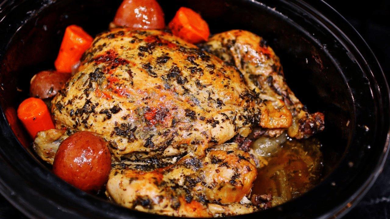 Easy crockpot whole chicken and vegetables, a browned whole chicken in a slow cooker with carrots and potatoes