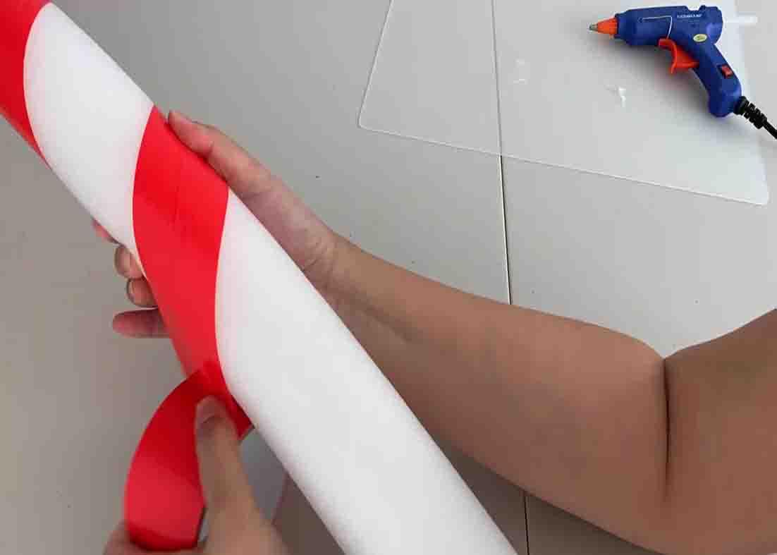 Wrapping the pool noodle with duct tape to make a giant lollipop