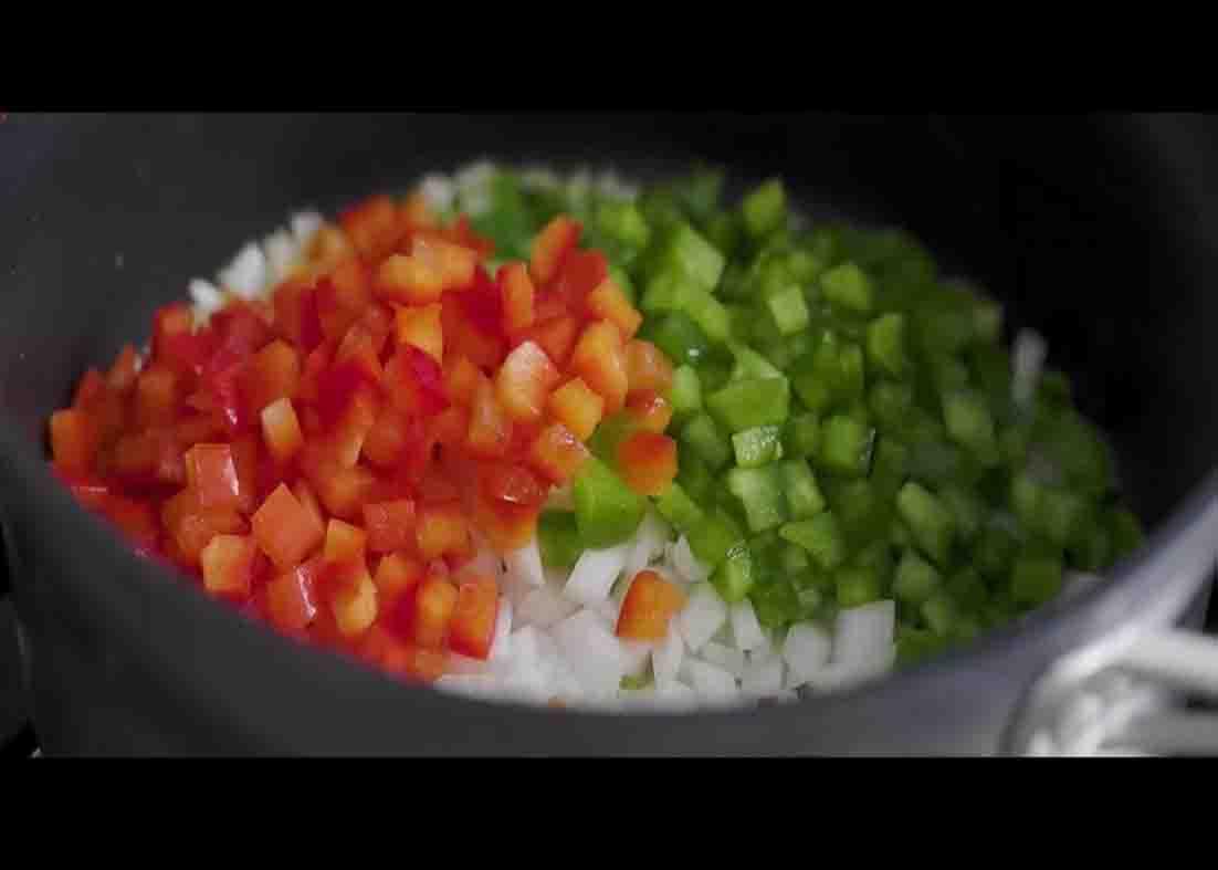 Sauteing the chopped onion and bell peppers for the rice and beans recipe