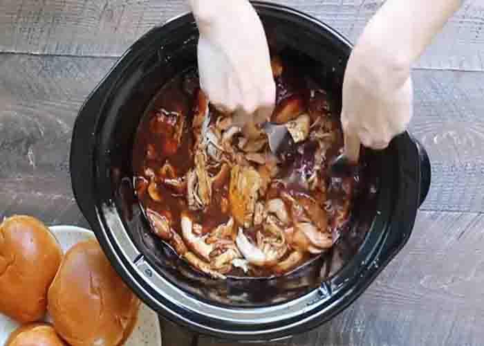 Shredding the root beer chicken in the slow cooker