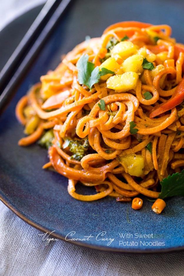 Vegan coconut curry with spiralized sweet potato noodles, peppers, broccoli and mango in a bowl for a thirty minute dinner
