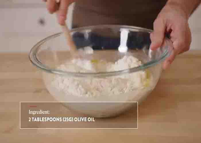 Combining the ingredients to make the grandma pizza
