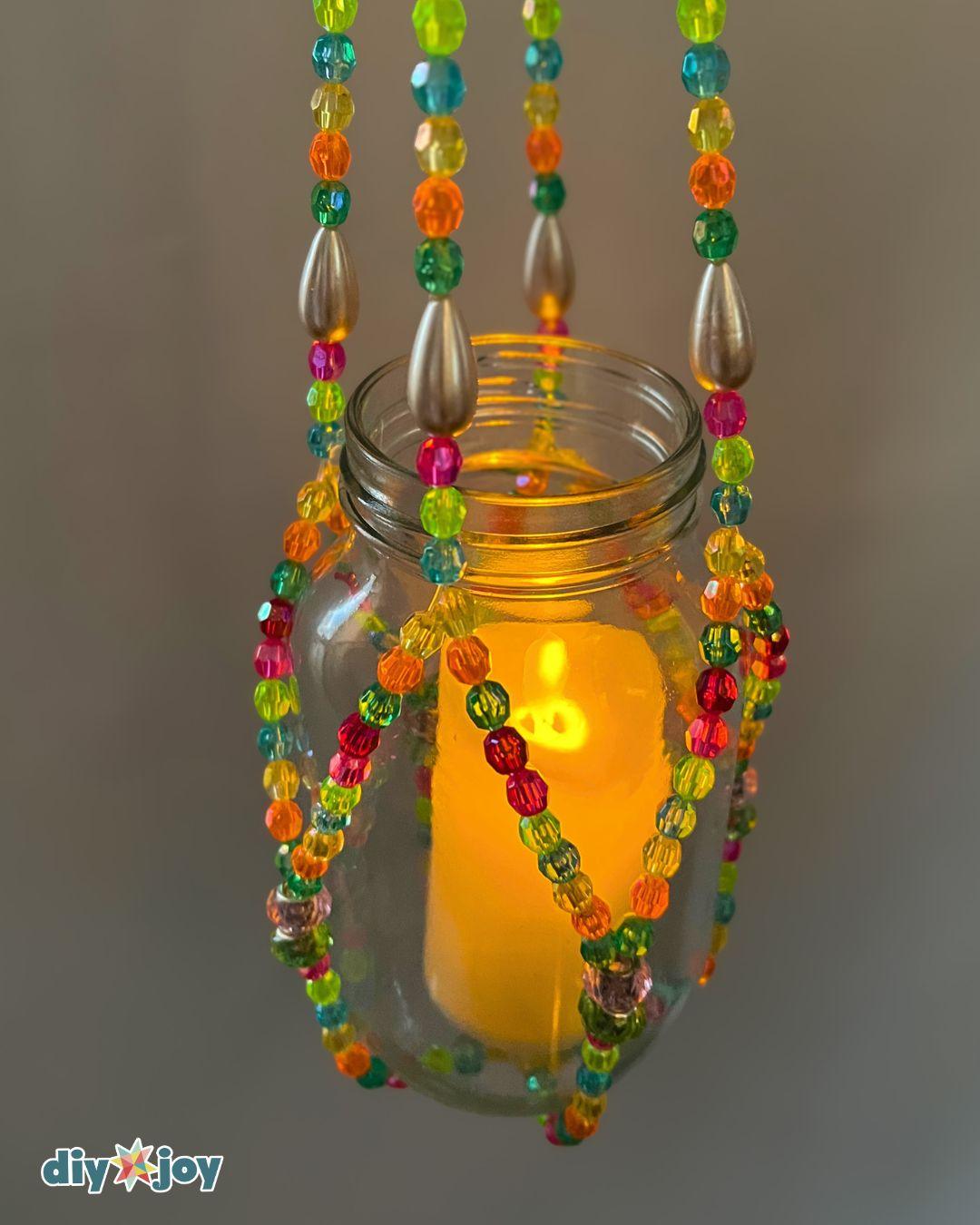 DIY plant hanger ideas using glass beads and fishing line instead of macrame cord, holding a small pot indoors