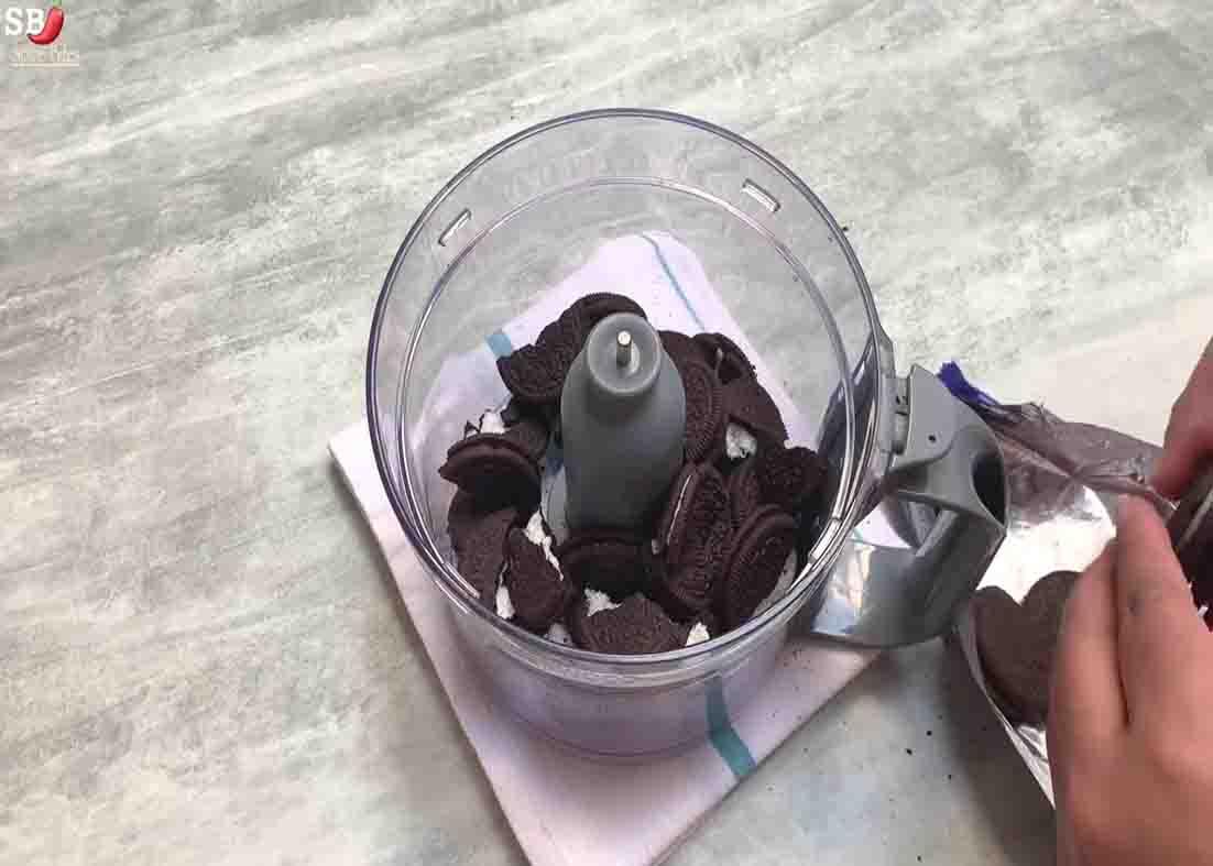 Finely crushing the Oreo cookies to make the Oreo cake