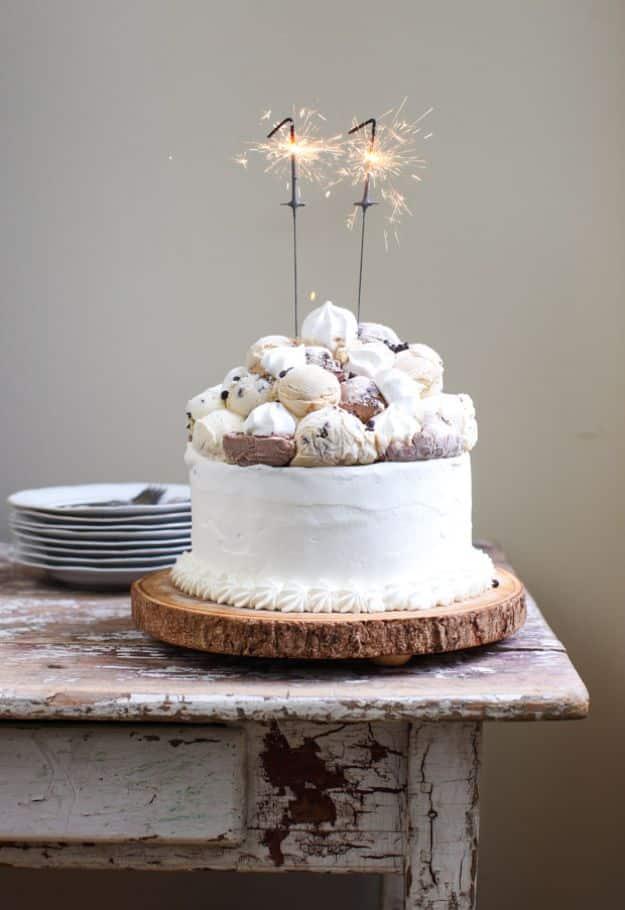 Layered ice cream birthday cake piled with toasted meringue mounds, a frozen showstopper dessert recipe for a celebration