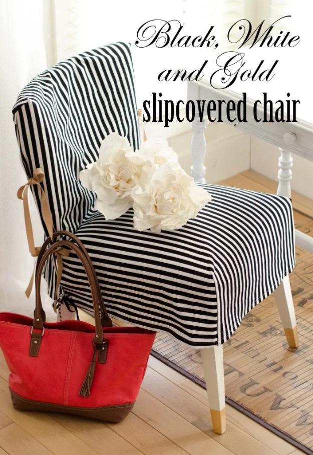 Black white and gold slipcovered chair graphic showing bold stripes, a red tote bag and a bunch of white flowers