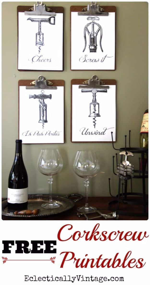 Corkscrew free wall art printables, four vintage corkscrew engravings clipped to wooden clipboards on a wall above a wine