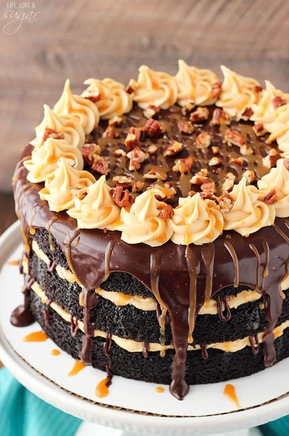 Turtle chocolate layer cake with caramel frosting swirls, toasted pecans and dark chocolate ganache drips
