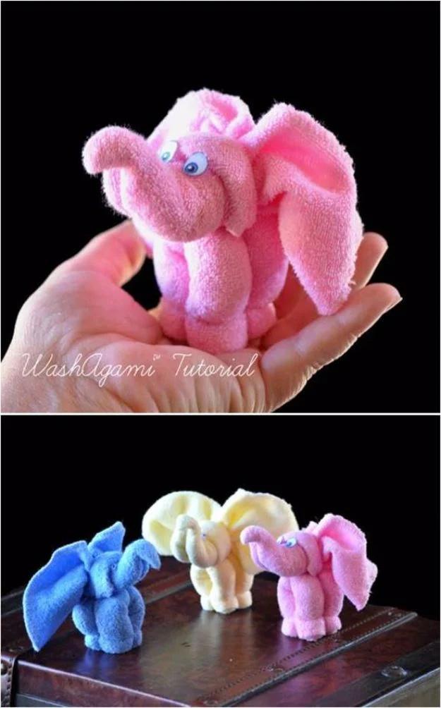 DIY towel elephant collage with a pink washcloth elephant held in one hand above a row in blue, cream and pink