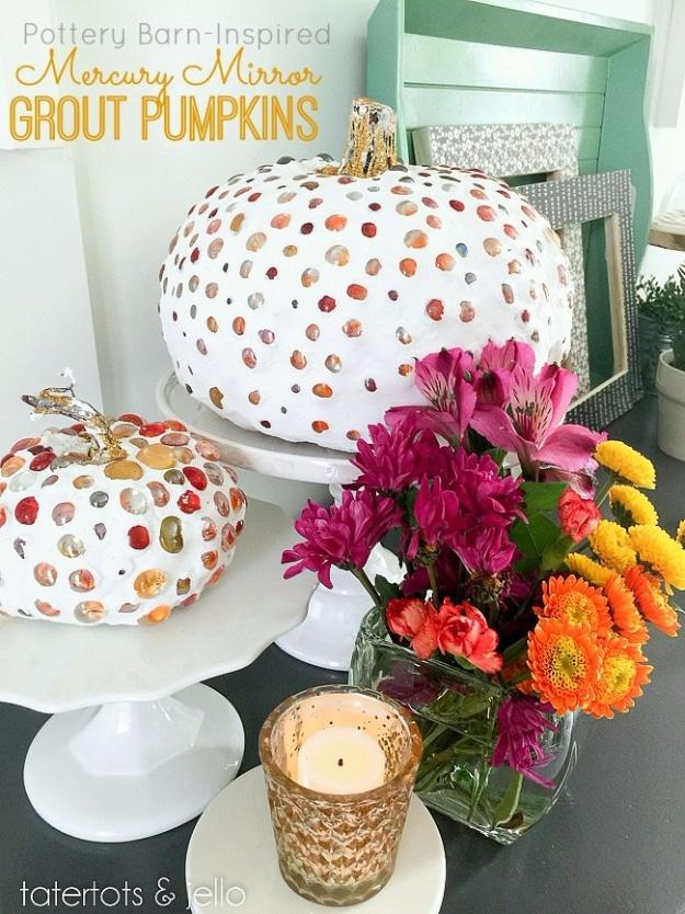 Gray grout covered craft pumpkins studded with flat mirrored glass marbles, one with a glittered stem