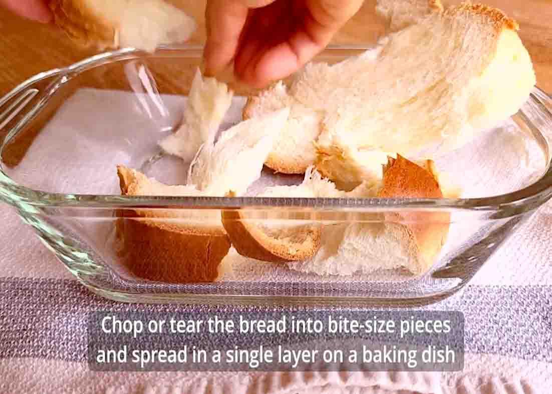 Layering the bite-size pieces of the bread in a baking dish