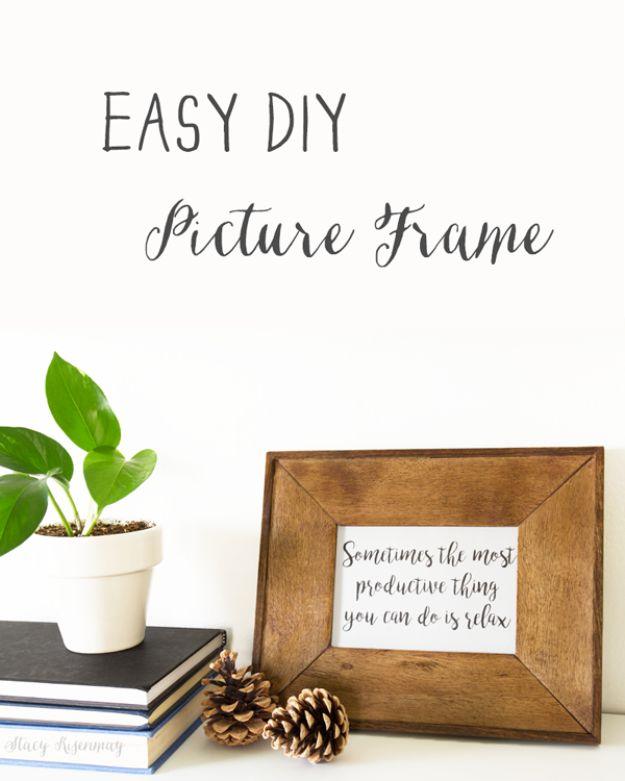 A slim stained wood frame holds a black and white print, propped on a shelf against a whitewashed plank wall