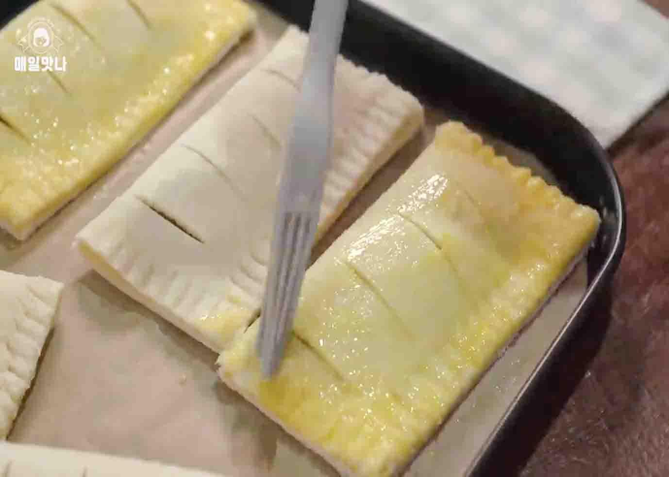 Brushing some egg wash on top of the apple pies