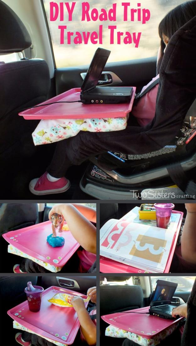 DIY road trip travel tray, a pink cookie sheet on a child's lap in a car seat holding a portable DVD player