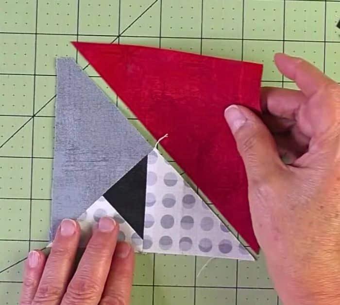 Easy to make double aster quilt block, pieced fabric units laid out with the background square at the center