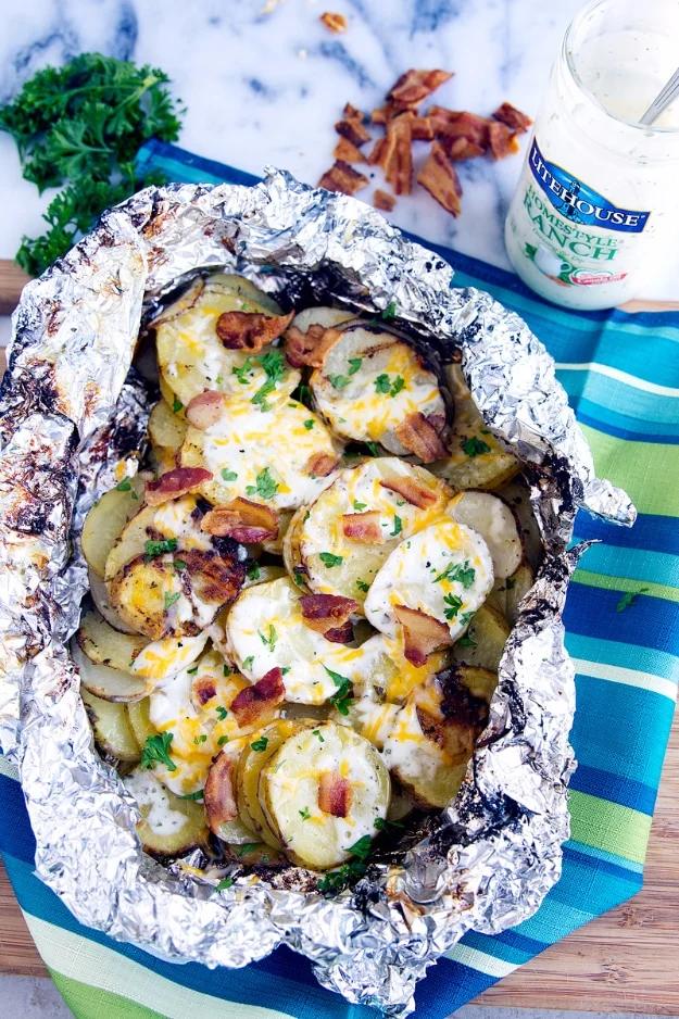 Camping recipe: bacon ranch grilled potatoes foil packed with cheddar cheese and ranch dressing for the fire