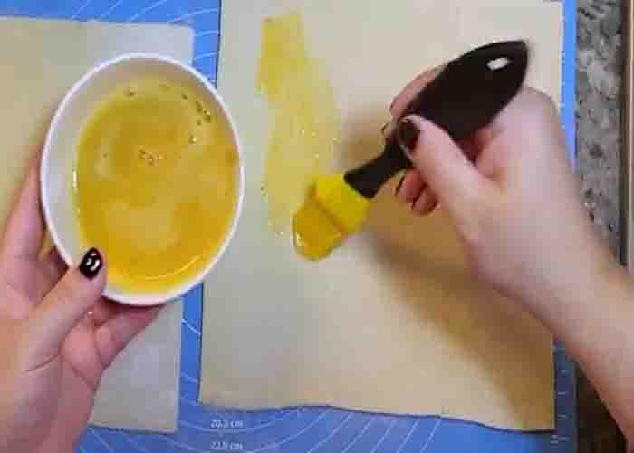 Brushing the puff pastry sheet with egg wash