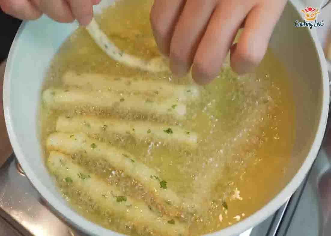 Frying the homemade potato sticks