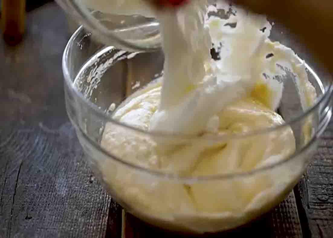 Folding the cheese and meringue to make the cheese souffle