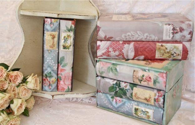 Vintage wallpaper covered book boxes, five book shaped boxes papered in pink and grey florals with printed spine labels