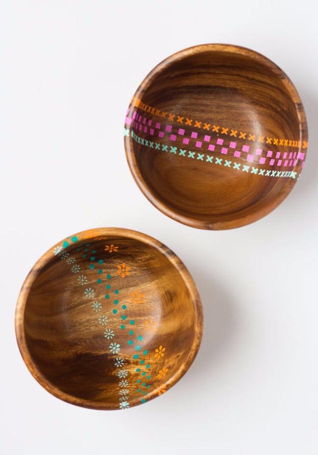 Painted wood bowls, two thrift store wooden bowls stenciled with rows of pink, orange and teal crosses and daisies