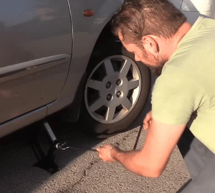 Putting a Jack on the Front Wheel of the Car