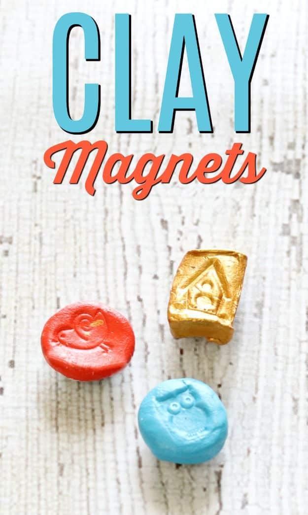 Four small air dry clay magnets in red, gold, turquoise and cream with pressed designs, on a woven mat