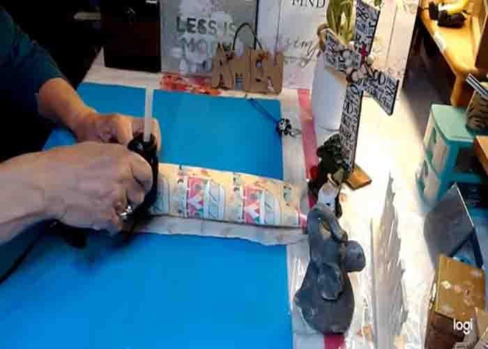 Wrapping the pool noodle with fabric to make the body of the gnome