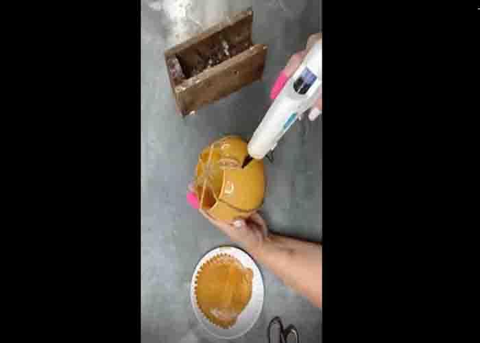Gluing the jute rope to make the sections of the pumpkin