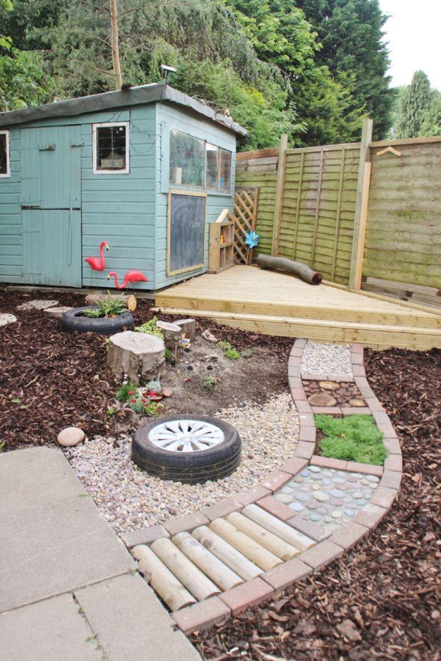 Curved barefoot sensory path of wood rounds, pebbles, gravel and planting sections beside a garden shed