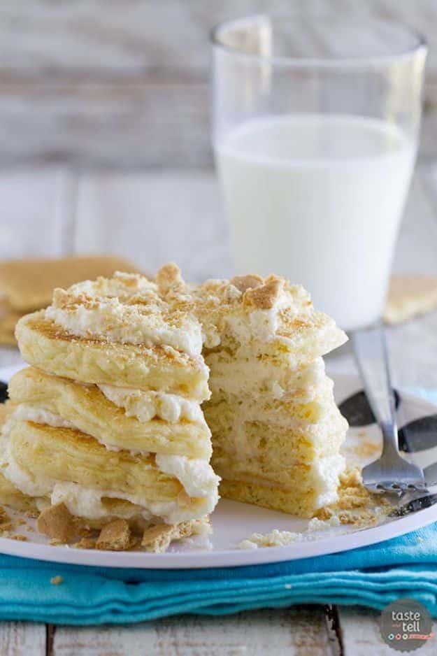 Cheesecake pancakes stacked with cream cheese filling between the layers and crushed cookie crumbs on top