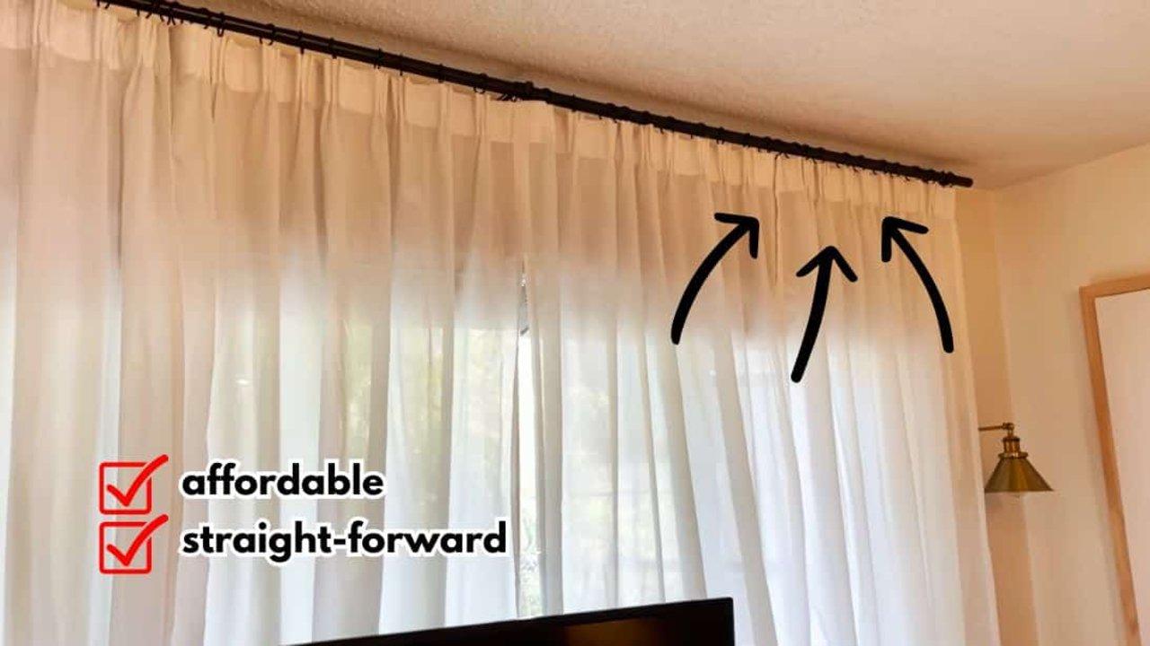 DIY pinch pleat curtains with a tailored pleated header hanging on a rod, a no sew IKEA curtain hack for a fuller look