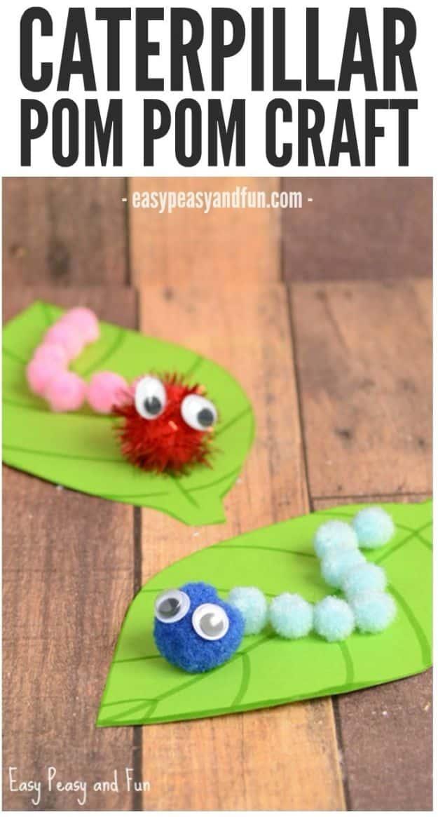 Two pom pom caterpillars in pink and blue glued along green paper leaves with googly eyes, under a typeset title