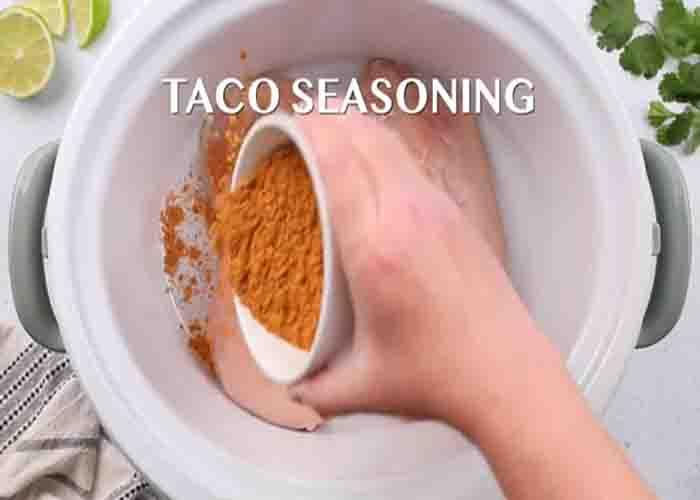 Seasoning the chicken with taco seasoning