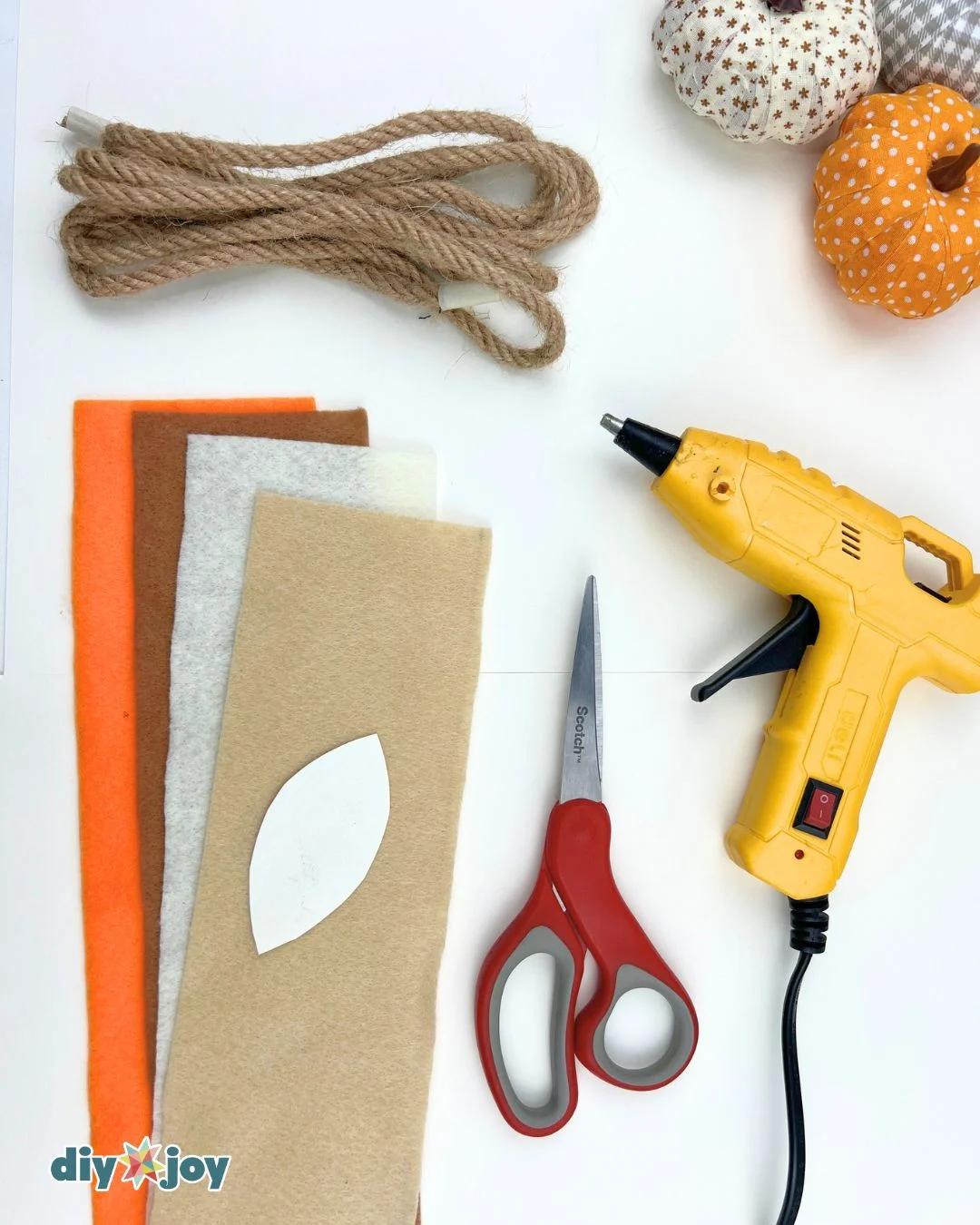 Felt fall garland materials: felt fabric, rope, and small pom-poms for this DIY fall leaf garland project.