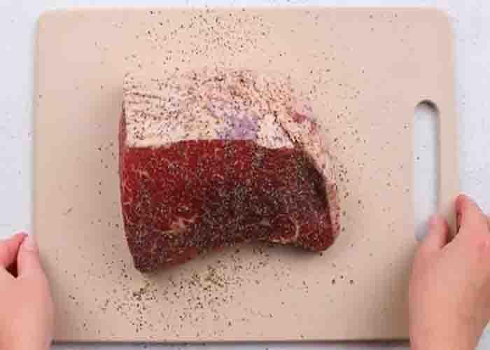 Rubbing the pot roast with seasonings