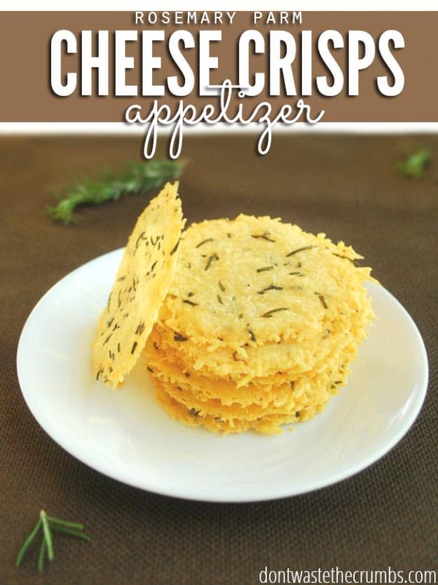 Parmesan cheese crisps party appetizer with chopped rosemary, baked golden and lacy on parchment paper