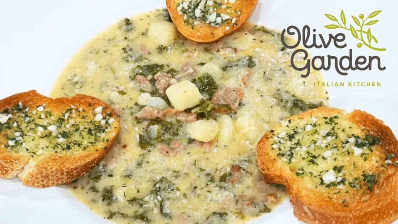 Zuppa toscana with kale, sausage and potato under herb butter toasts, Olive Garden Italian Kitchen logo in the corner