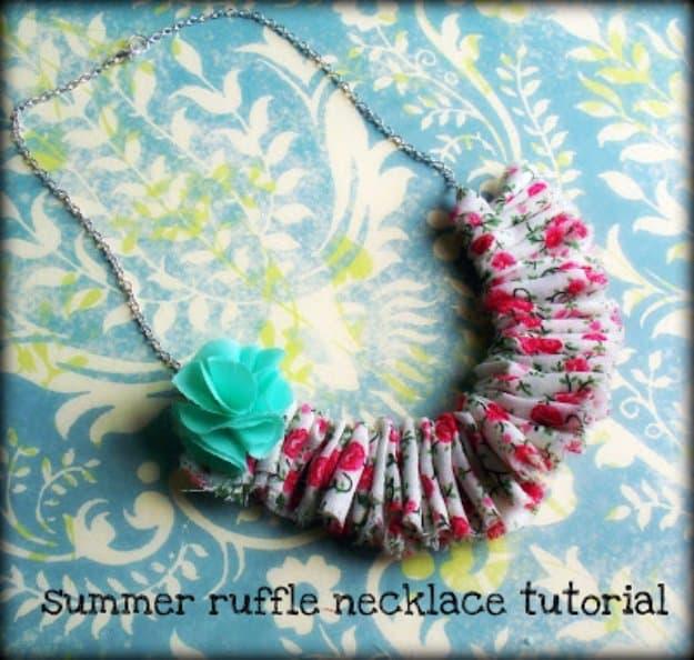 Fabric ruffle necklace in pink rose print gathered onto a silver chain with a mint green fabric flower accent