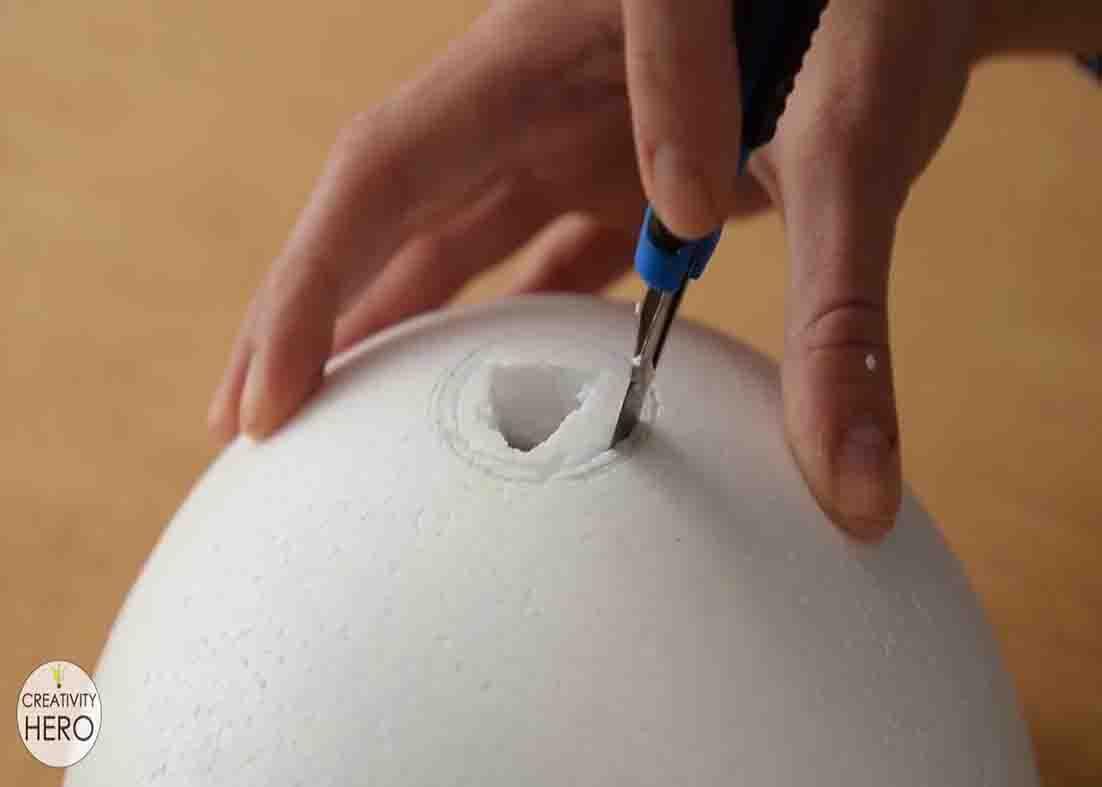 Making a hole to fit the bulb socket to the styrofoam
